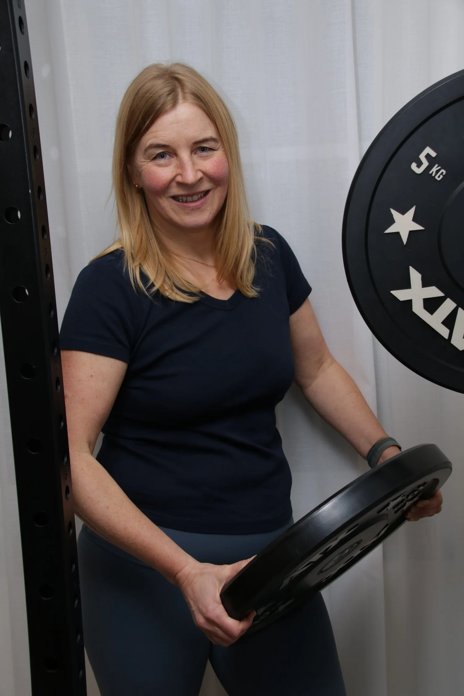 Doris Erdt in ihrem Trainingsraum mit Hantelscheiben